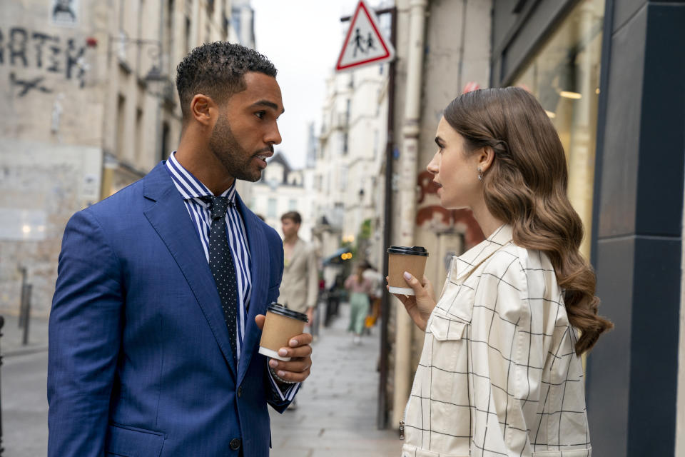 Lucien Laviscount as Alfie with Lily Collins in “Emily in Paris.” - Credit: STÉPHANIE BRANCHU/NETFLIX