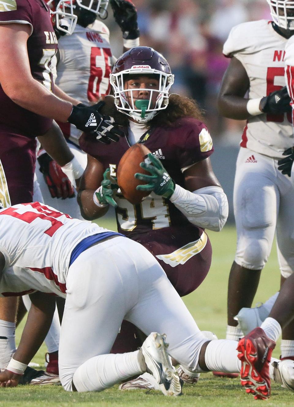 Kevin Downing recovers a North Miami fumble in the Eagles season home opener.