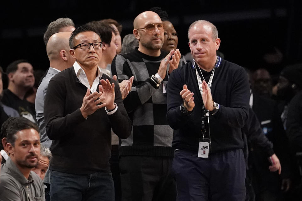 Joe Tsai, left, co-founder and executive vice chairman of Alibaba Group and the new owner of the Brooklyn Nets and the New York Liberty, cheers on the Nets during the second half of an NBA basketball game against the New York Knicks, Tuesday, Nov. 30, 2021, in New York. The Nets won 112-110. (AP Photo/Mary Altaffer)