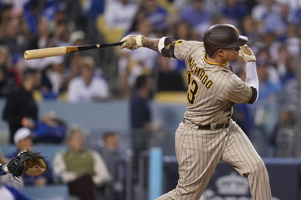 FILE - San Diego Padres' Manny Machado follows through on an RBI-double during the third inning in Game 2 of a baseball NL Division Series against the Los Angeles Dodgers, Oct. 12, 2022, in Los Angeles. Machado has agreed to a new $350 million, 11-year contract that will keep him with the San Diego Padres through 2033, according to a person with knowledge of the deal, on Sunday, Feb. 26, 2023. (AP Photo/Ashley Landis, File)