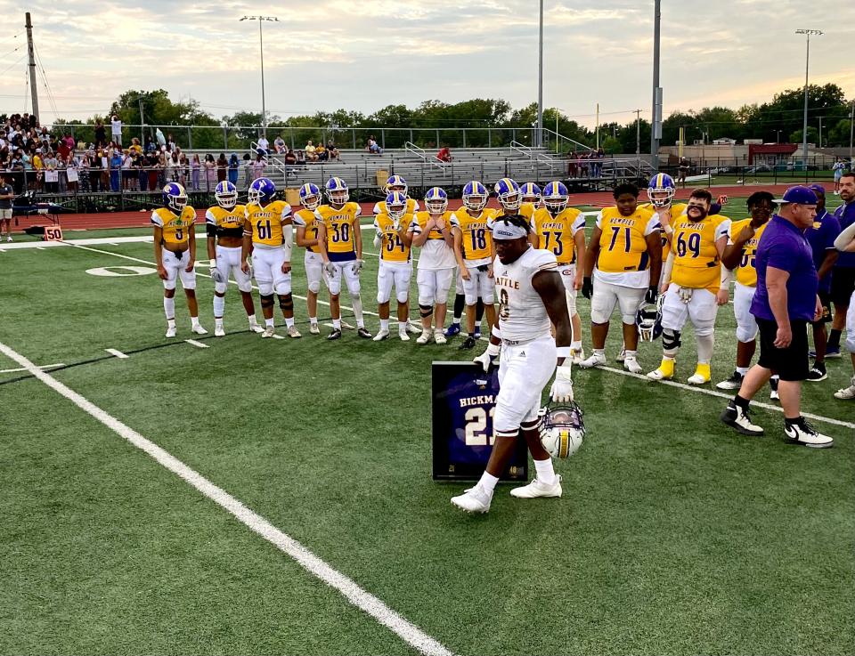 Battle running back Rickie Dunn Jr. accepts his late father's Hickman jersey before the Spartans played the Kewpies on Friday night. Rickie Dunn Sr., who was murdered in 2014, was a star football player at Hickman.