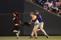 Colorado Rockies security personnel attempts to restrain a fan after they ran onto the field in the seventh inning during the game against the Los Angeles Dodgers at Coors Field on August, 2, 2016. (Photo by Michael Reaves/The Denver Post via Getty Images)