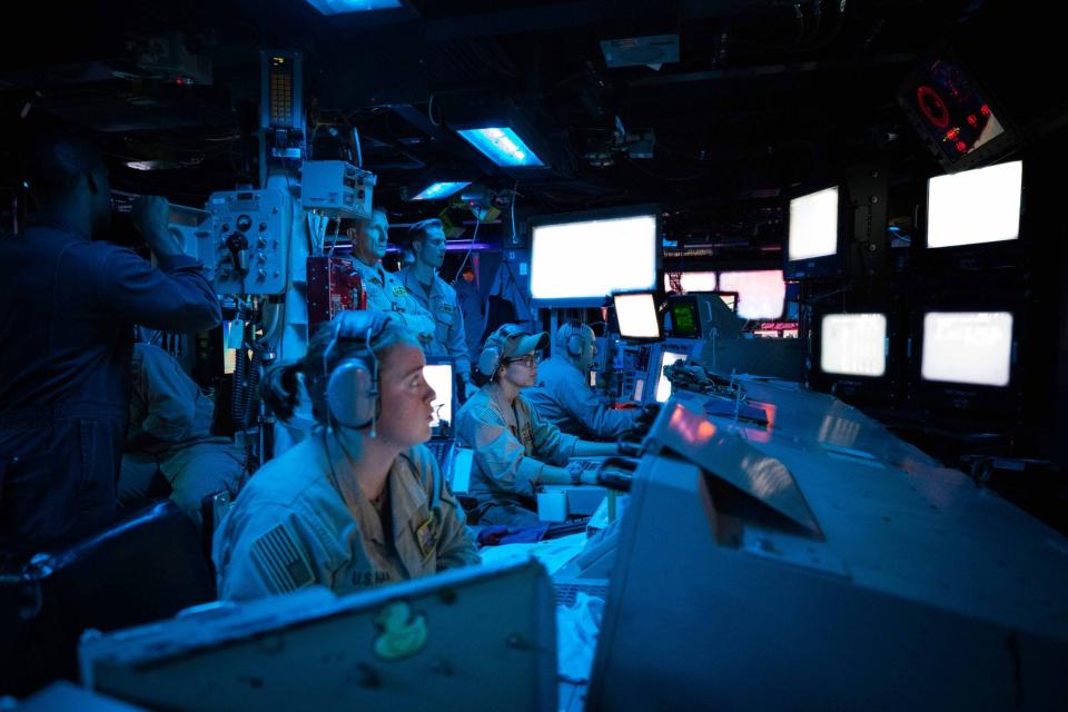 RED SEA (Oct. 19, 2023) Sailors assigned to the Arleigh Burke-class guided-missile destroyer USS Carney (DDG 64) stand watch in the ship’s Combat Information Center during an operation to defeat a combination of Houthi missiles and unmanned aerial vehicles, Oct. 19. Carney is deployed to the U.S. 5th Fleet area of operations to help ensure maritime security and stability in the Middle East region. (U.S. Navy photo by Mass Communication Specialist 2nd Class Aaron Lau)