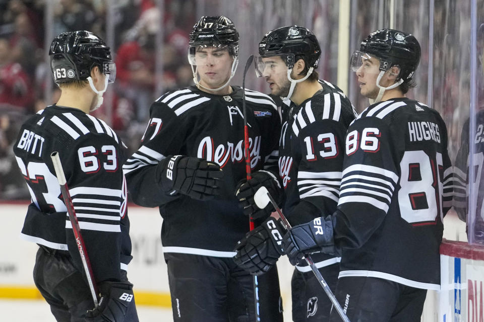 New Jersey Devils center Nico Hischier (13) celebrates with his teammates after scoring against the Carolina Hurricanes during the second period of an NHL hockey game, Saturday, March 9, 2024, in Newark, N.J. (AP Photo/Mary Altaffer)