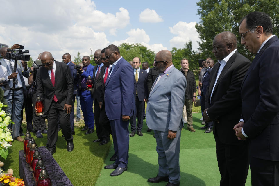 First row from right, Egypt's Prime Minister Mustafa Madbuly, South African President Cyril Ramaphosa, President of the Union of Comoros Azali Assoumani, Senegal's President Macky Sall, and Zambia's President Hakainde Hichilema attend a commemoration ceremony at a site of a mass grave in Bucha, on the outskirts of Kyiv, Ukraine, Friday, June 16, 2023. South African President Cyril Ramaphosa arrived in Ukraine on Friday as part of a delegation of African leaders and senior officials seeking ways to end Kyiv's 15-month war with Russia. (AP Photo/Efrem Lukatsky)