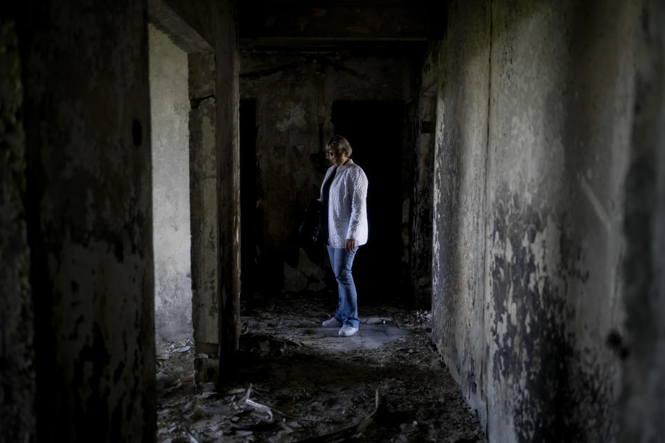 Natalia Makhno stands inside her home destroyed by attacks in Borodyanka, on the outskirts of Kyiv, Ukraine, Tuesday, May 31, 2022. (AP Photo/Natacha Pisarenko)