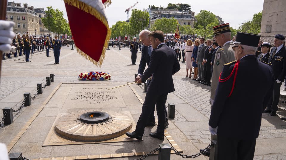 Biden and Macron participate in a ceremony at the Tomb of the Unknown Soldier under the Arc de Triomphe on June 8, 2024. - Evan Vucci/AP