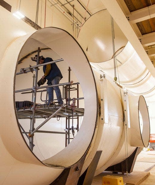 As part of the Safety Significant Confinement Ventilation System, this Salt Reduction Building (SRB) ductwork will connect to fans that will move air from the underground to the New Filter Building after removing salt. The ductwork is now connected to the ceiling of the SRB.