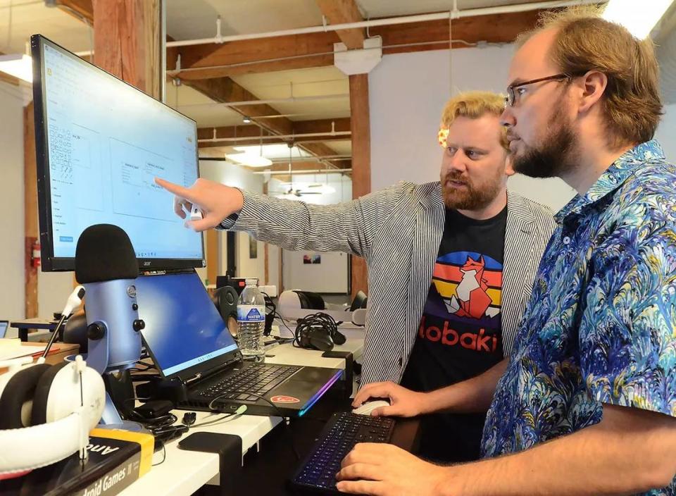 Lobaki Vice President of Development Vinny Jordan and Senior Programmer Michael Peacock discuss a project.