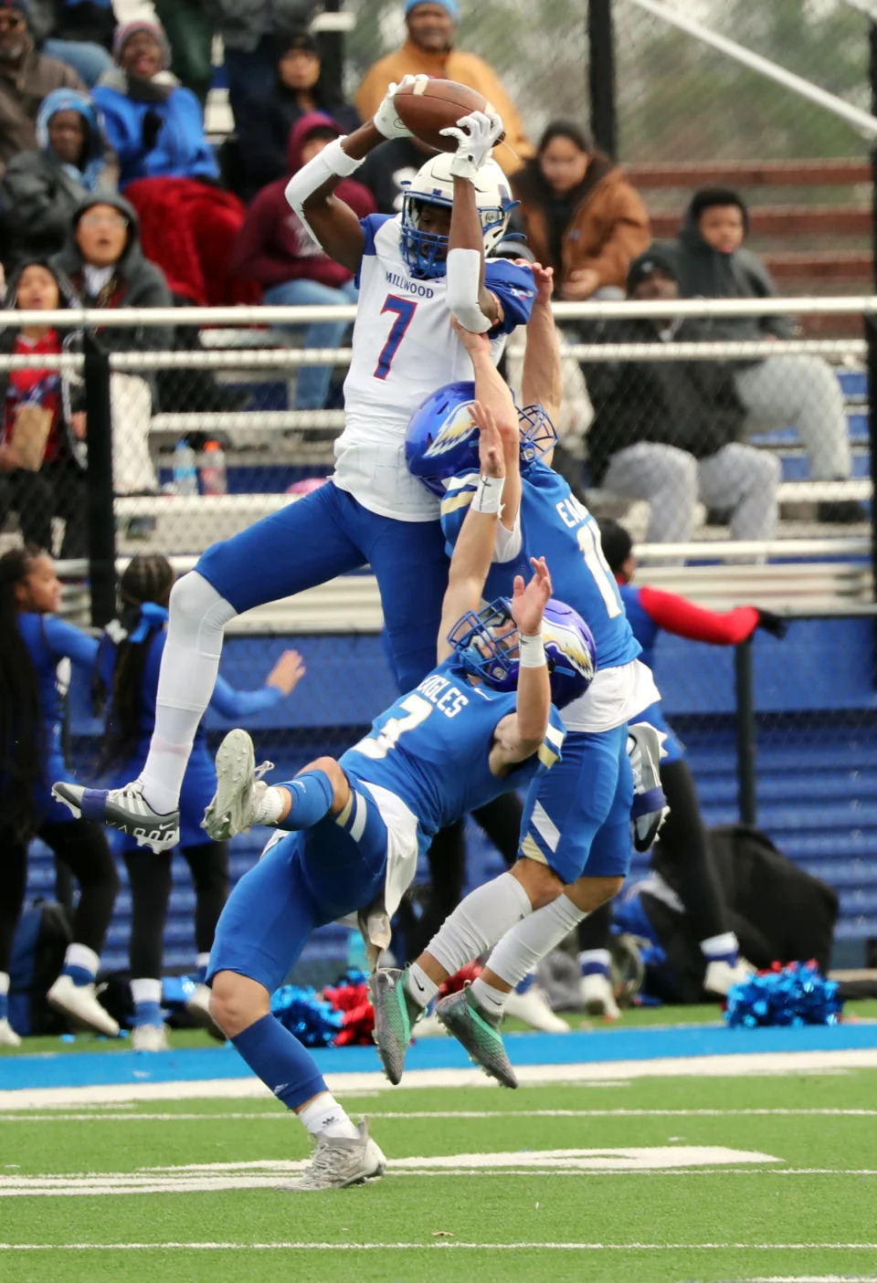 Millwood's Jaden Nickens catches a touchdown pass between Sequoyah Claremore defenders Dylan Burks and JT Keeler on Nov. 25 in Harrah.