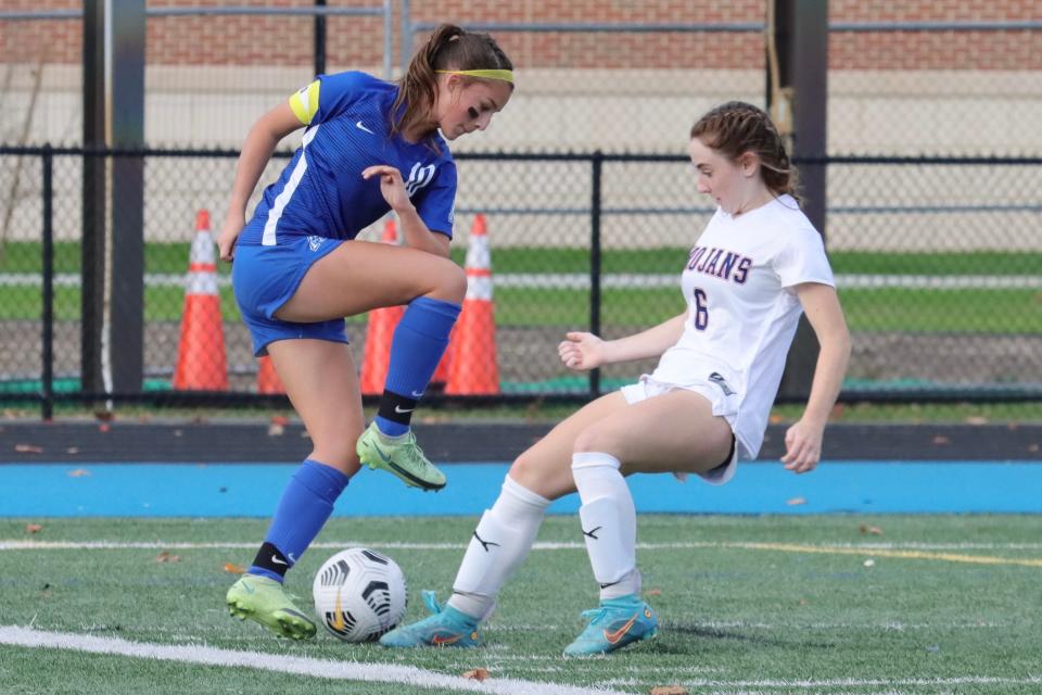 Bridgewater-Raynham's Isabella Johnson and Attleboro's Kacey Parker jostle for control of the ball during a Division 1 Preliminary Round game.