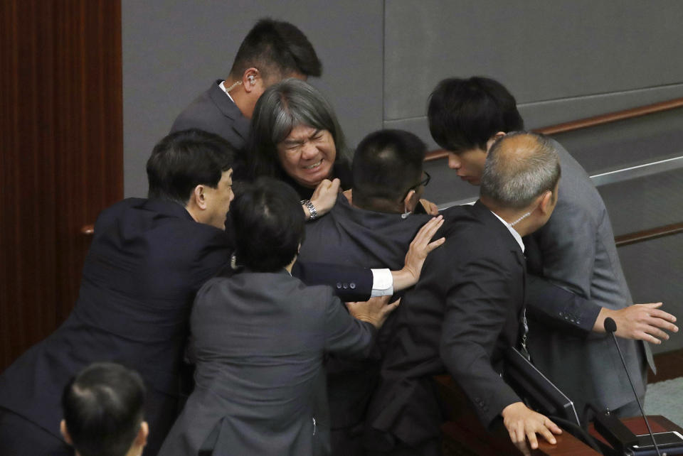 Leung Kwok-hung tries to break through the security guards