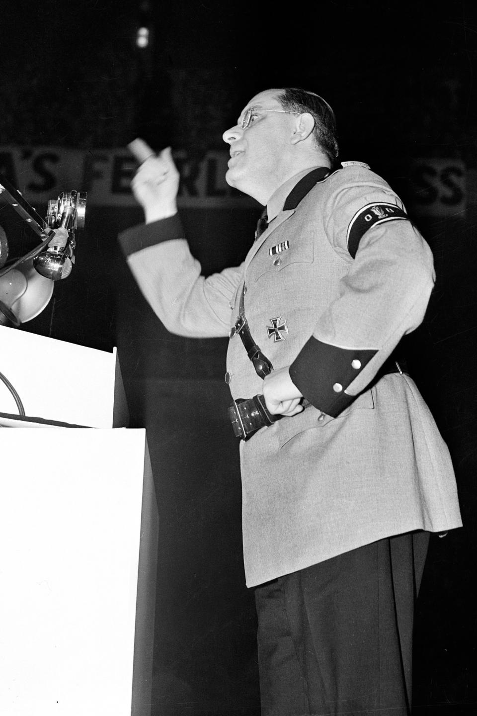 FILE - In this Feb. 20, 1939, file photo, Fritz Kuhn, leader of the German American Bund, speaks at a pro-Hitler rally at New York's Madison Square Garden wearing the uniform of a storm trooper. The rally that took place 80 years ago this week is the subject of a short documentary that’s up for an Oscar this Sunday, Feb. 24, 2019. The film directed by Marshall Curry is called a “A Night at the Garden.” (AP Photo, File)