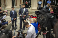 FILE - In this June 4, 2020, file photo, Arbery family attorney Lee Merritt, center right, speaks to members of the media during a recess in the preliminary hearing of Travis McMichael, Gregory McMichael and William Bryan, in Brunswick, Ga. The three are accused of shooting Ahmaud Arbery while he ran through their neighborhood in February. Jury selection in the case is scheduled to begin Monday, Oct. 18. (AP Photo/Stephen B. Morton, File)