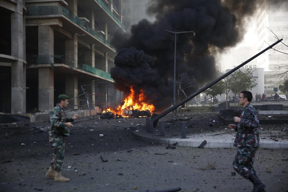 Lebanese army personnel run at the site of an explosion in Beirut's downtown area December 27, 2013. The explosion rocked the Lebanese capital on Friday, causing an unknown number of casualties. The blast was heard across the city and a plume of black smoke was seen rising in the downtown business district near the Phoenicia Hotel. (REUTERS/Steve Crisp)