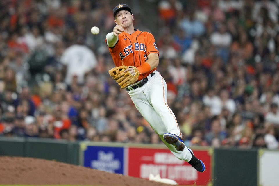 Houston Astros third baseman Alex Bregman attempts to throw out Seattle Mariners' Julio Rodriguez during the ninth inning of a baseball game, Friday, Aug. 18, 2023, in Houston. Rodriguez was safe at first. (AP Photo/Eric Christian Smith)