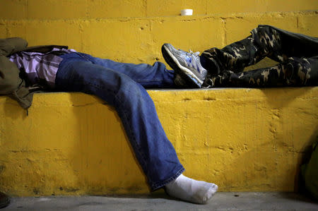 Honduran migrants, part of a caravan trying to reach the U.S., sleep at the stands of a rodeo in Esquipulas, Guatemala October 16, 2018. REUTERS/Jorge Cabrera