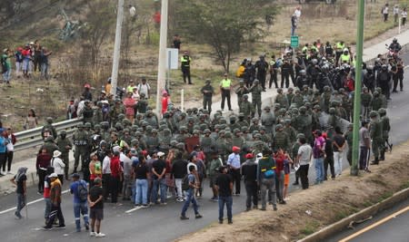 Soldiers prepare to remove a road block during protests after Ecuador's President Lenin Moreno's government ended four-decade-old fuel subsidies, in Calderon near Quito