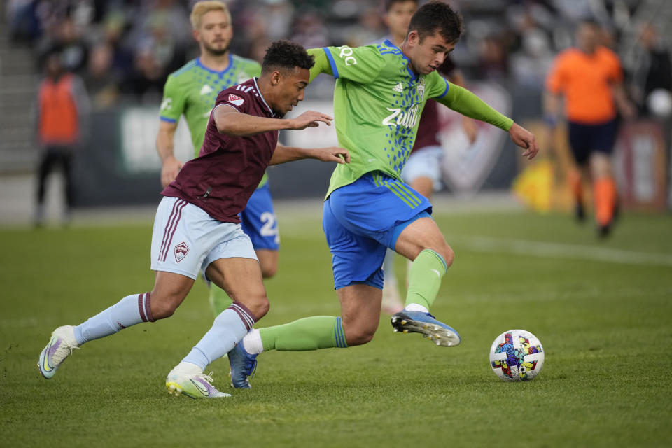 Colorado Rapids forward Jonathan Lewis, left, and Seattle Sounders defender Jackson Ragen battle for control of the ball in the second half of an MLS soccer match, Sunday, May 22 2022, in Commerce City, Colo. (AP Photo/David Zalubowski)