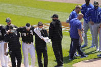 Chicago White Sox's Jose Abreu, left, heads to the dugout as Kansas City Royals' Hunter Dozier heads to his dugout after they collided along the first base line in the second inning of the first game of a baseball doubleheader Friday, May 14, 2021, in Chicago. (AP Photo/Charles Rex Arbogast)