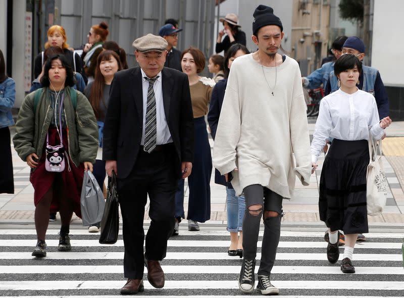 FILE PHOTO: Pedestrians cross the street at a crosswalk at Omotesando shopping district in Tokyo