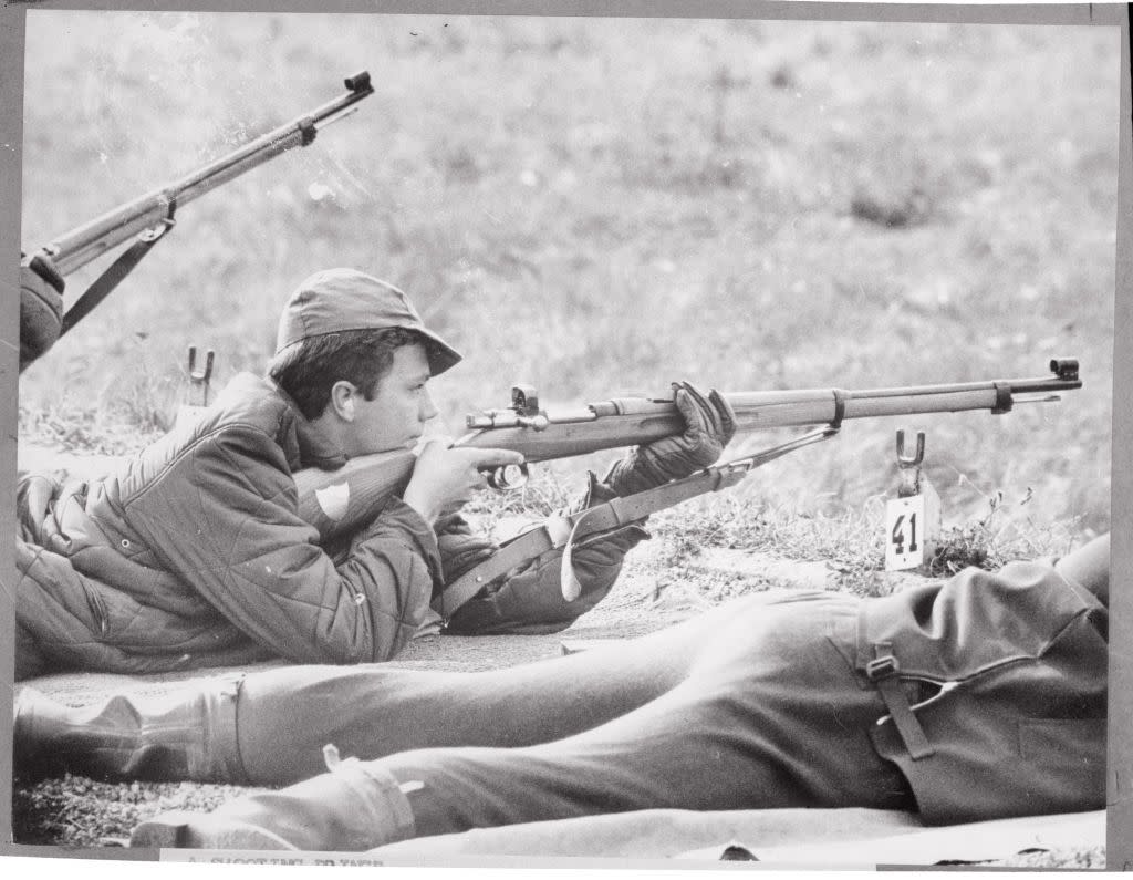 prince carl gustaf aiming a gun