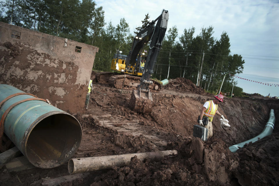 FILE - In an Aug. 21, 2017 file photo, workers make sure that each section of the Enbridge replacement Line 3 that is joined passes muster in Superior, Wisc. After President Joe Biden revoked Keystone XL's presidential permit and shut down construction of the long-disputed pipeline that was to carry oil from Canada to Texas, opponents of other pipelines hoped the projects they've been fighting would be next. (Richard Tsong-Taatarii /Star Tribune via AP)