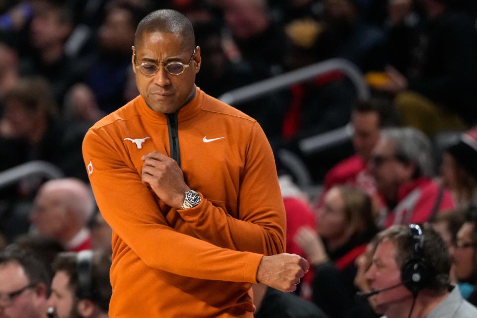 Texas Longhorns head coach Rodney Terry pumps his fist after a play in the first half of the NCAA Big 12 basketball game between the Cincinnati Bearcats and the Texas Longhorns at Fifth Third Arena in Cincinnati on Tuesday, Jan. 9, 2024.
