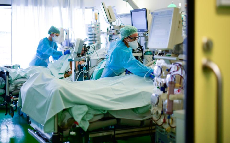 Medical staff take care of a COVID-19 patient in an intensive care unit at the university hospital of Aachen, western Germany, on April 15, 2020.