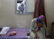 A woman waits to give a nasal swab sample to test for COVID-19 at a medical camp in Mumbai, India, Saturday, Aug. 8, 2020. As India hit another grim milestone in the coronavirus pandemic on Friday, crossing 2 million cases and more than 41,000 deaths, community health volunteers went on strike complaining they were ill-equipped to respond to the wave of infection in rural areas. (AP Photo/Rajanish Kakade)