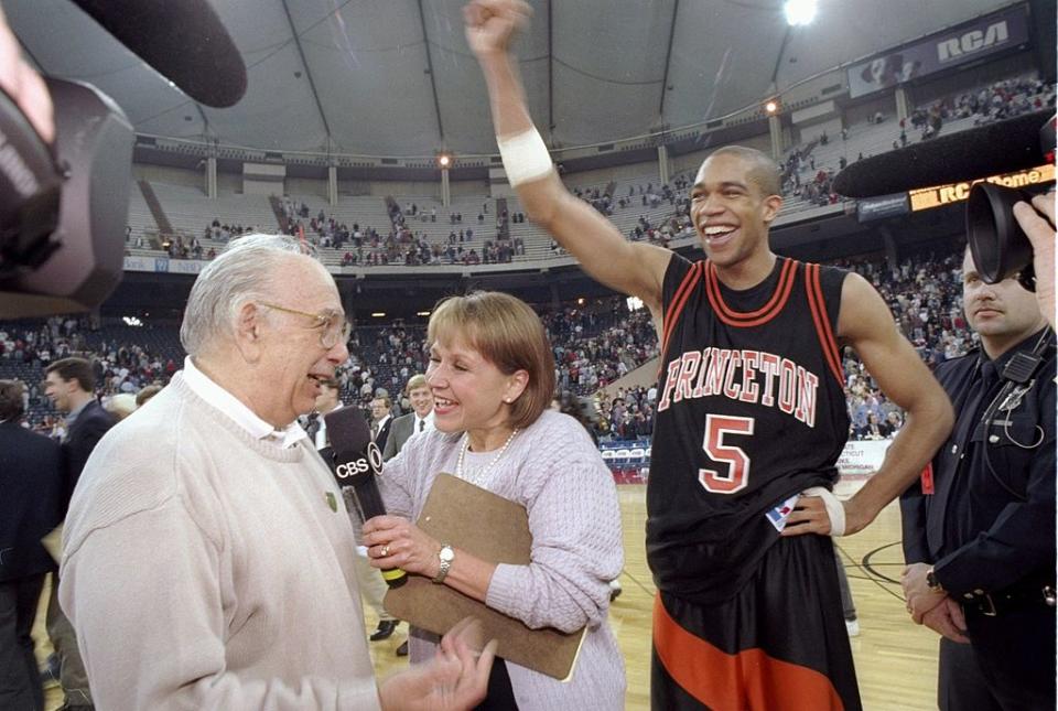 Guard Sydney Johnson and coach Pete Carril of the Princeton Tigers celebrate after a game against the UCLA Bruins at the RCA Dome in Indianapolis, Indiana. Princeton won the game, 43-41.<span class="copyright">Jamie Squire /Allsport—Getty Images</span>