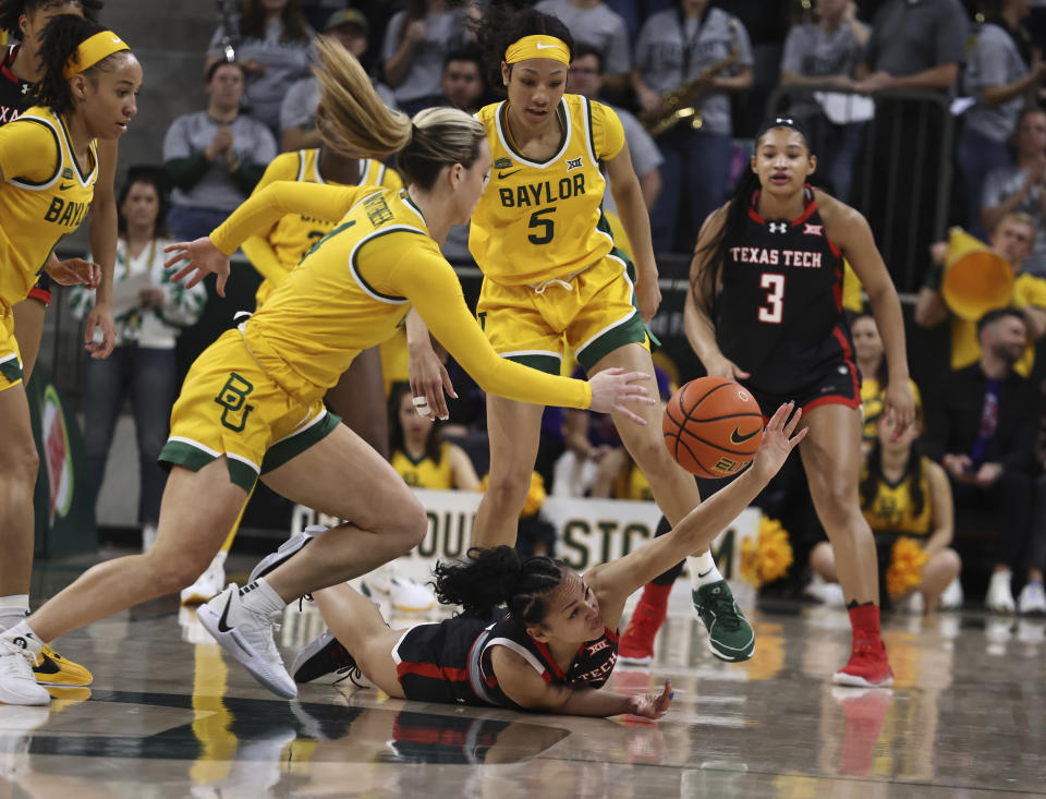 Texas Tech guard Ashley Chevalier reaches for a loose ball with Baylor guard Jana Van Gytenbeek, left, and guard Darianna Littlepage-Buggs, right, in the first half of an NCAA college basketball game, Sunday, Feb. 18, 2024, in Waco, Texas. (Rod Aydelotte/Waco Tribune-Herald via AP)