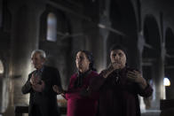 FILE - In this Nov. 12, 2016 file photo, Iraqi Christians pray at the Church of the Immaculate Conception, damaged by Islamic State fighters during their occupation of Qaraqosh, east of Mosul, Iraq. Iraq was estimated to have more than 1 million Christians before the 2003 U.S.-led invasion that toppled dictator Saddam Hussein. Now, church officials estimate only few hundred remain within Iraq borders. The rest are scattered across the globe, resettling in far-flung places like Australia, Canada and Sweden as well as neighboring countries. (AP Photo/Felipe Dana, File)