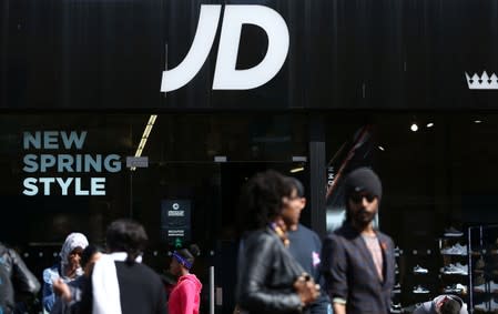 FILE PHOTO: People pass a JD Sports store in London