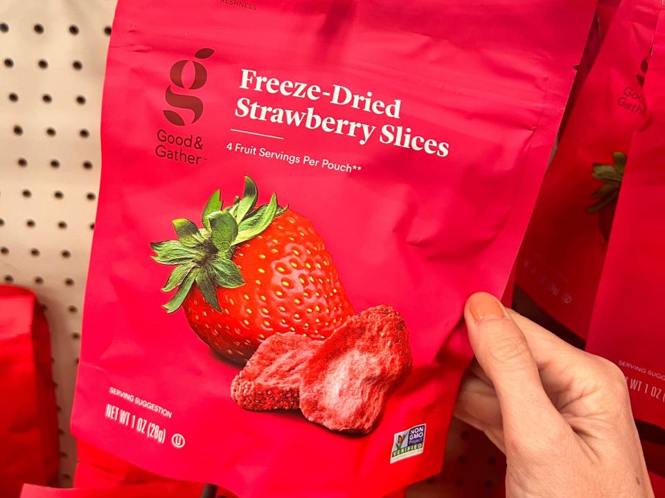 hand grabbing a bag of freeze dried strawberries at a target