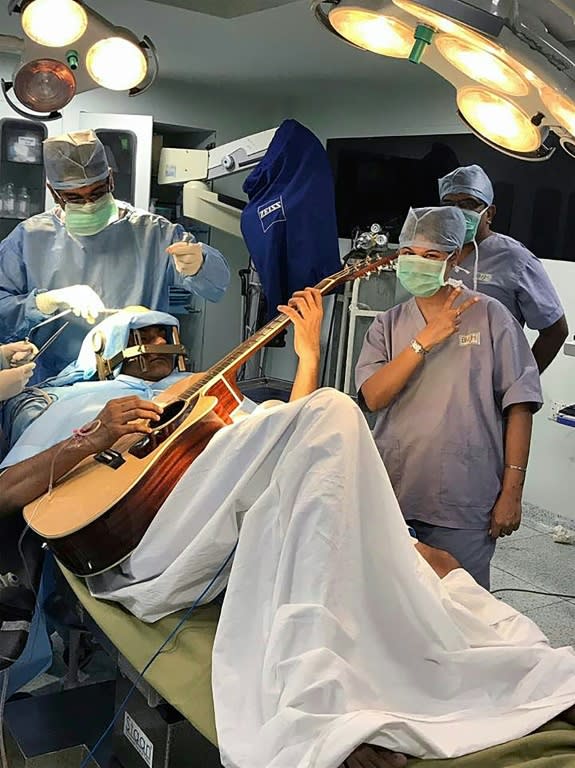 Abhishek Prasad plays the guitar during brain surgery in Bangalore