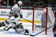 Los Angeles Kings goaltender Calvin Petersen (40) lets the puck slip past for a Colorado Avalanche left wing J.T. Compher (37) hat trick during the second period of an NHL hockey game Wednesday, May, 12, 2021, in Denver. (AP Photo/Jack Dempsey)