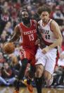 Houston Rockets' James Harden (13) drives against Portland Trail Blazers' Robin Lopez (42) during the first half of game four of an NBA basketball first-round playoff series game in Portland, Ore., Sunday March 30, 2014. (AP Photo/Greg Wahl-Stephens)