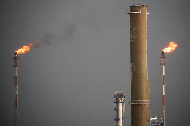 FILE PHOTO: Flames come out of chimeys at the French oil giant Total Refinery in Donges