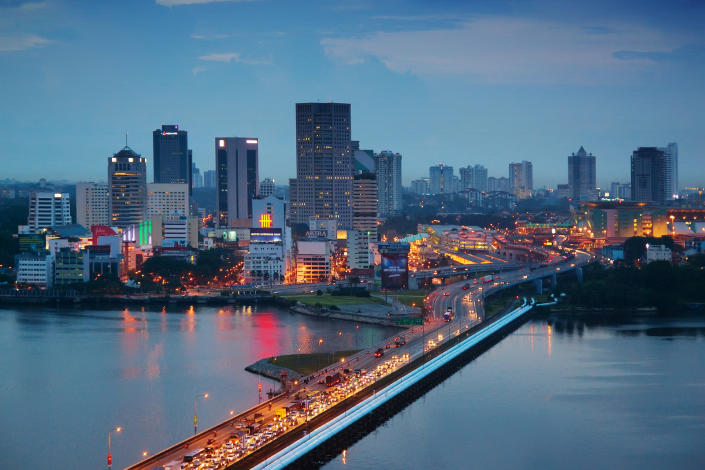 The Malaysian city of Johor Bahru, with heavy traffic on the Johor-Singapore Causeway at dusk, illustrating talks on establishing a special economic zone.