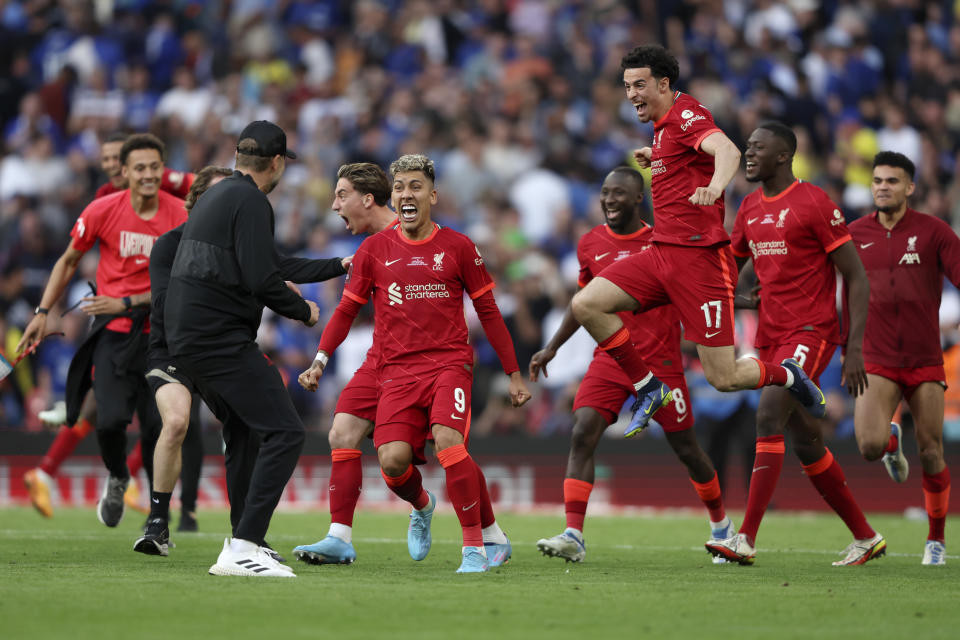 Liverpool players runs towards Liverpool's manager Jurgen Klopp, left, celebrating after scoring the winning penalty in a penalty shootout at the end of the English FA Cup final soccer match between Chelsea and Liverpool, at Wembley stadium, in London, Saturday, May 14, 2022. Liverpool won 6-5 on penalties after the game ended in a goalless draw. (AP Photo/Ian Walton)