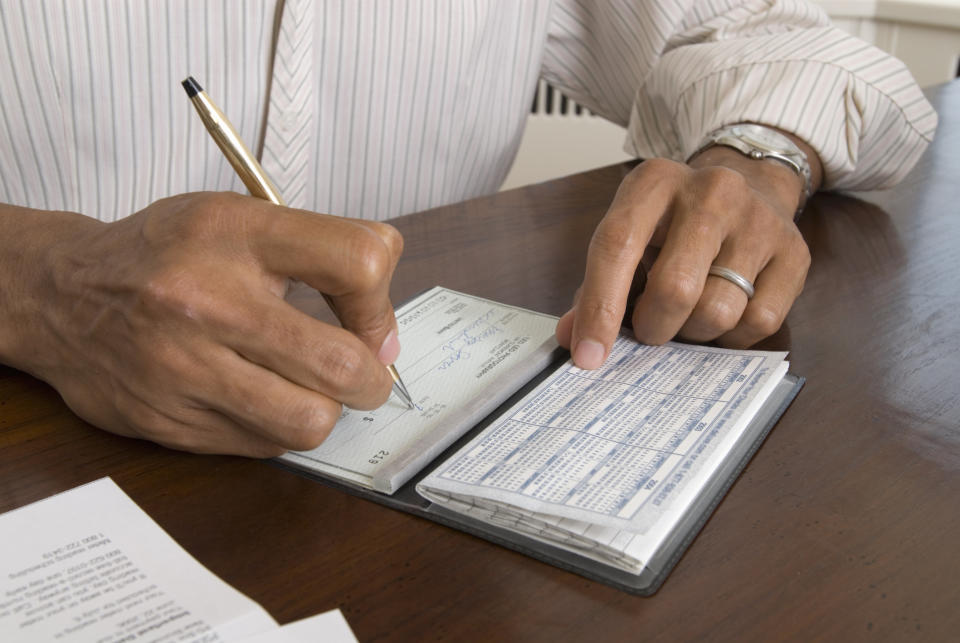 person writing out a check