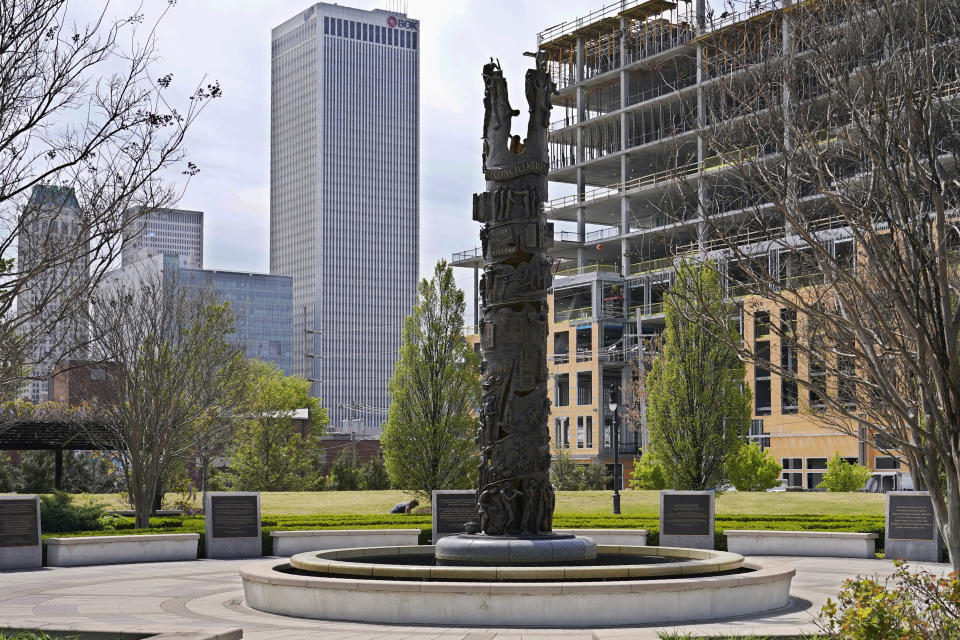 A sculpture commemorating the Tulsa Race Massacre stands in John Hope Franklin Reconciliation Park in Tulsa, Okla., on Wednesday, April 14, 2021, with new construction in the background. (AP Photo/Sue Ogrocki)