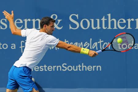 Aug 20, 2017; Mason, OH, USA; Grigor Dimitrov (BUL) returns a shot against Nick Kyrgios (AUS) in the finals during the Western and Southern Open at the Lindner Family Tennis Center. Mandatory Credit: Aaron Doster-USA TODAY Sports