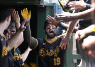 Pittsburgh Pirates' Jared Triolo celebrates in the dugout after his two-run home run off Chicago Cubs starting pitcher Kyle Hendricks during the third inning of a baseball game Friday, May 17, 2024, in Chicago. (AP Photo/Charles Rex Arbogast)