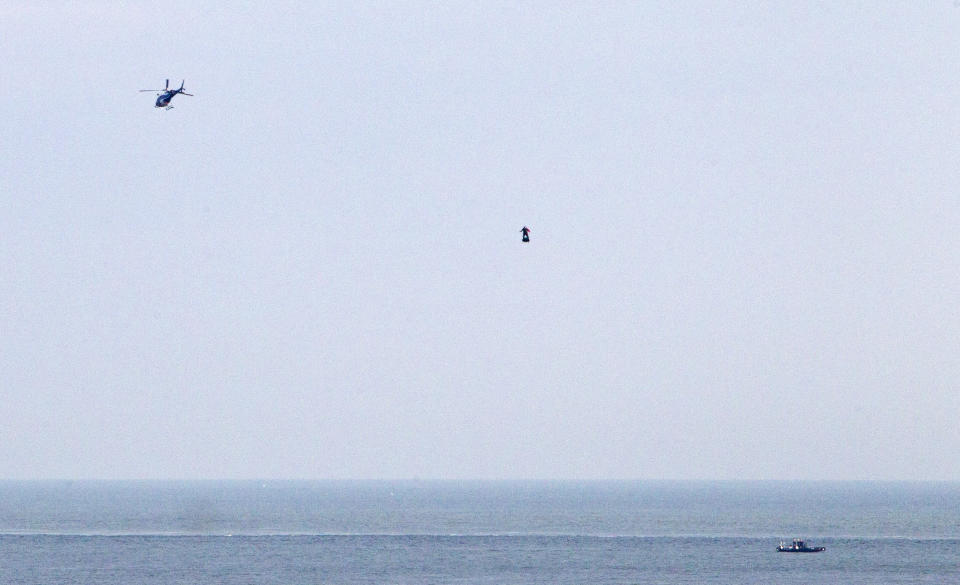 Franky Zapata, a 40-year-old inventor, takes to the air in Sangatte, Northern France, at the start of his attempt to cross the channel from France to England, aboard his flyboard, Sunday Aug. 4, 2019. Zapata will try again Sunday, to traverse the English Channel on a flying board after his first attempt failed when he crashed into a refueling boat 20 kilometers (12 miles) into the trip. (AP Photo/Michel Spingler)