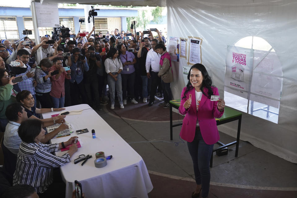 Alejandra del Moral, who is running for governor of Mexico state with the PRI-PAN-PRD coalition, shows her ink-stained thumb after casting her ballot during the local elections in Cuautitlán Izcalli, Mexico state, Mexico, Sunday, June 4, 2023. (AP Photo/Marco Ugarte)