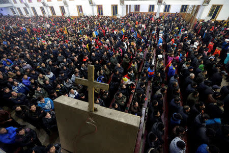 Catholics attend a Christmas eve mass at a Catholic church near the city of Taiyuan, Shanxi province, December 24, 2012. REUTERS/Jason Lee/File Photo