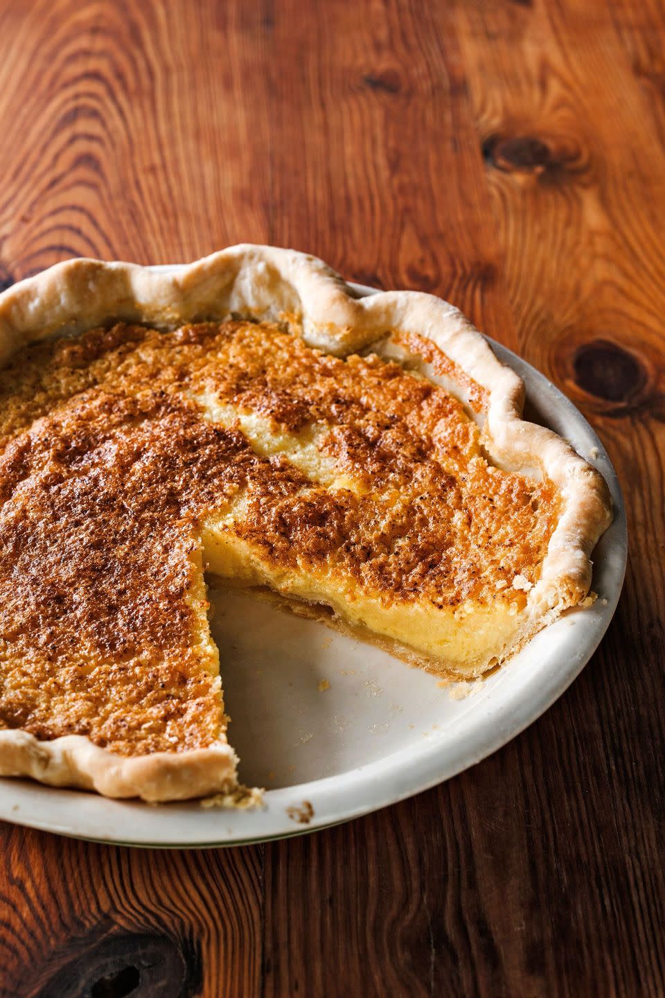 chess pie in a white pie dish with a slice removed