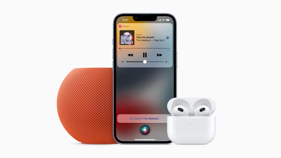 Apple iPhone between AirPods and a HomePod Mini